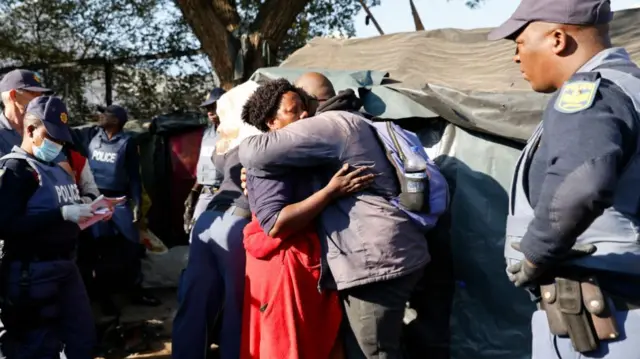 Migrants and police outside the UNHCR building in Pretoria, South Africa - 21 April 2023