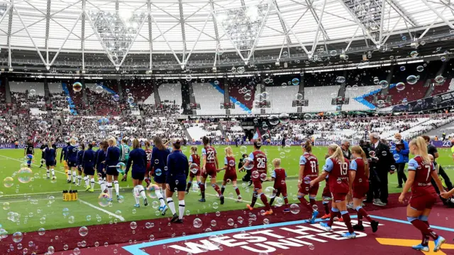 West Ham and Tottenham walking out to play at the London Stadium