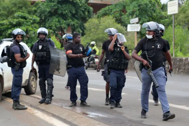 Policemen stand guard on a road on the French Indian Ocean island of Mayotte - 23 February 2022