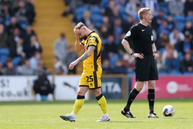 Rochdale's Danny Lloyd looks dejected as his side trail at Stockport