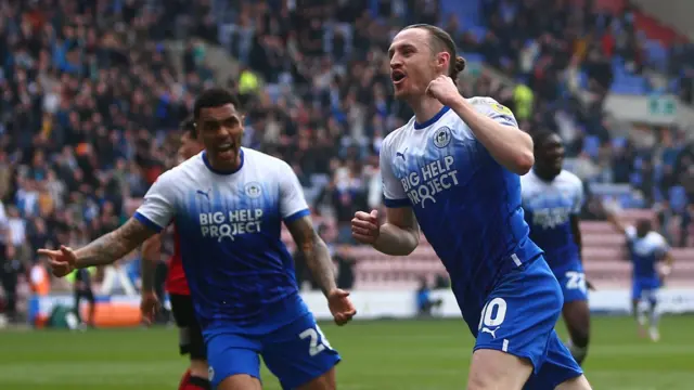 Will Keane celebrates giving Wigan the lead against Walsall