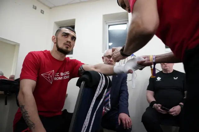 Shavkatdzhon Rakhimov has his hands wrapped