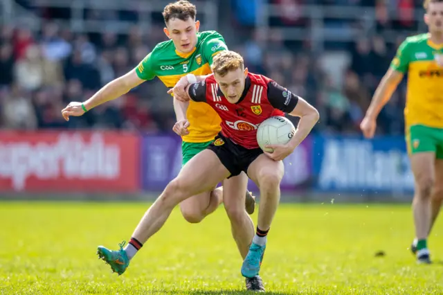 Down forward Liam Kerr gets a push from Caolan McGonagle