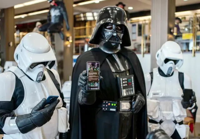 Members of the Sentinel Squad UK dressed as Darth Vader and Stormtroopers with their mobile phones during a test of a new emergency public alert system during the Sci Fi Scarborough at The Spa Complex in Scarborough