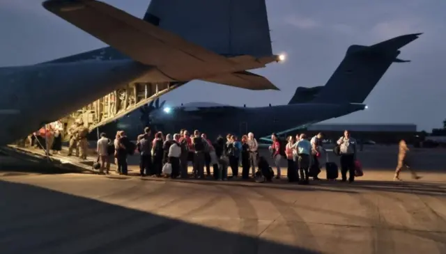 Italian citizens board an Italian Air Force C130 aircraft during their evacuation from Khartoum, Sudan