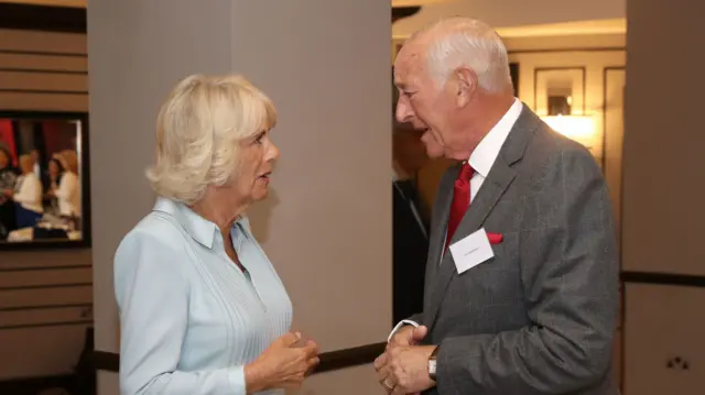 In this file photo from 2019, the then Duchess of Cornwall chats to Len Goodman at an event to celebrate the 90th anniversary of the British Dance Council