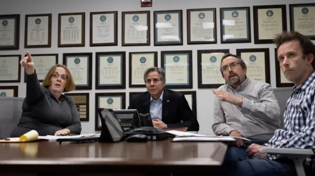 Antony Blinken (centre) sits alongside other staff members to discuss Sudan