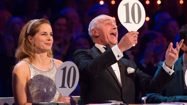 Darcey Bussell and Len Goodman on the panel of a Strictly Show both holding signs with 10 written on them