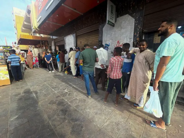 People gather to get bread during clashes between the paramilitary Rapid Support Forces and the army in Khartoum, Sudan 18 April, 2023.