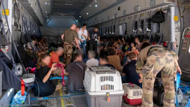 Blurred faces of citizens on a plane leaving Khartoum