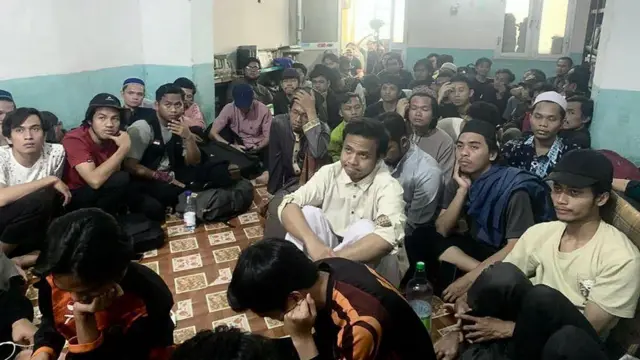 People sit on the floor of a room in Khartoum