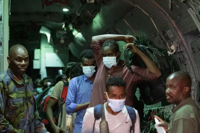 Evacuees from war-torn Sudan are processed by members of the Kenya Defence Forces (KDF) as they disembark from a military plane upon their arrival at the Jomo Kenyatta International Airport, in Nairobi, Kenya, on 24 April 2023