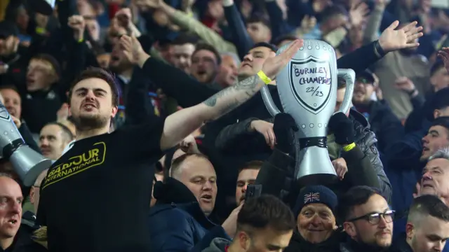 Burnley fan holds trophy