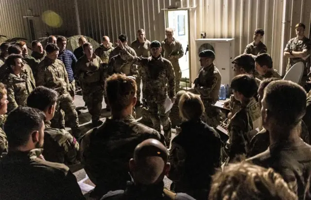 Personnel of the joint forces get briefed as they prepare to depart for Sudan to evacuate British embassy diplomats and their families, in RAF Akrotiri, Cyprus April 25, 2023