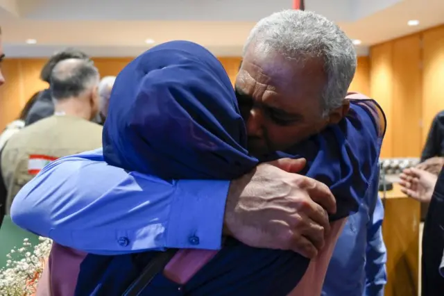 Lebanese citizen Ali Mazloum (R), evacuated from Sudan, hugs his wife after arriving at the Rafik Hariri international airport in Beirut, Lebanon, on 25 April 2023