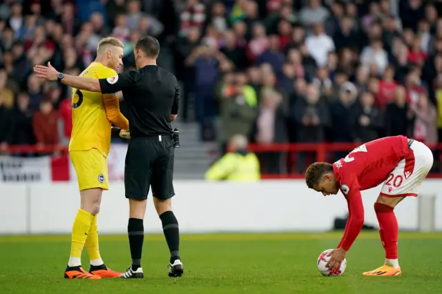 Nottingham forest forward Brennan Johnson places the ball on the penalty spot