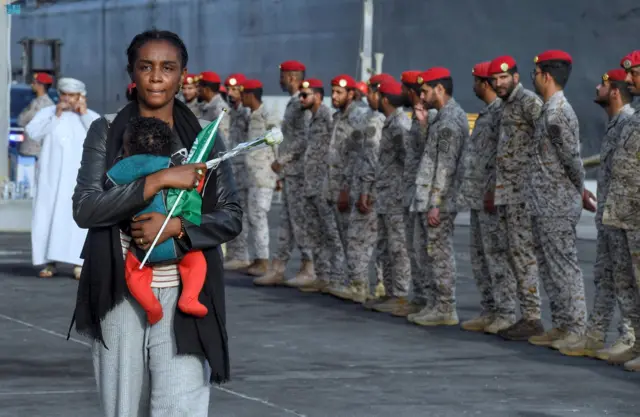 A woman with a baby at the port of Jeddah