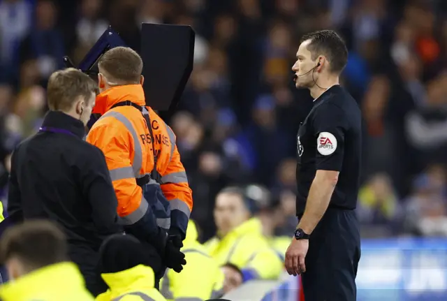 Referee Jarred Gillett checks the VAR monitor