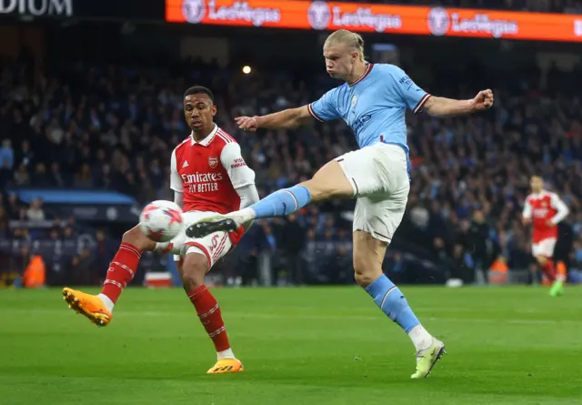 Manchester City striker Erling Haaland takes a shot against Arsenal