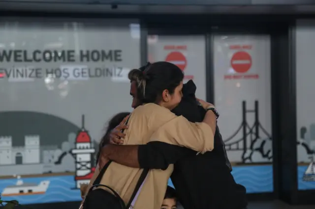 A man and woman hug at Istanbul airport