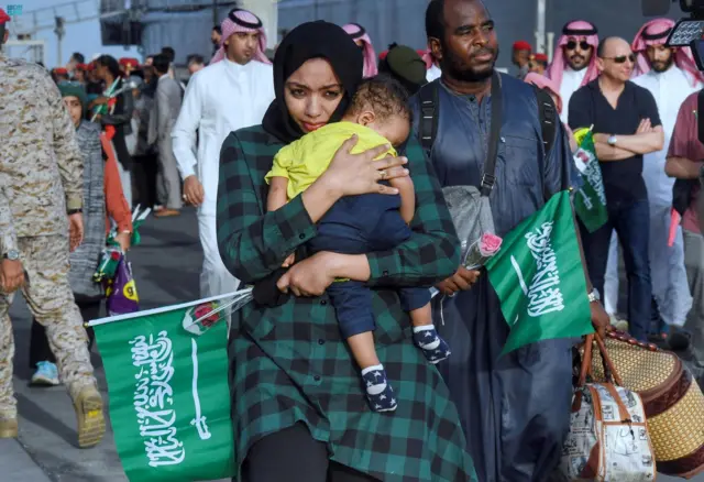 A woman with a baby at the port of Jeddah