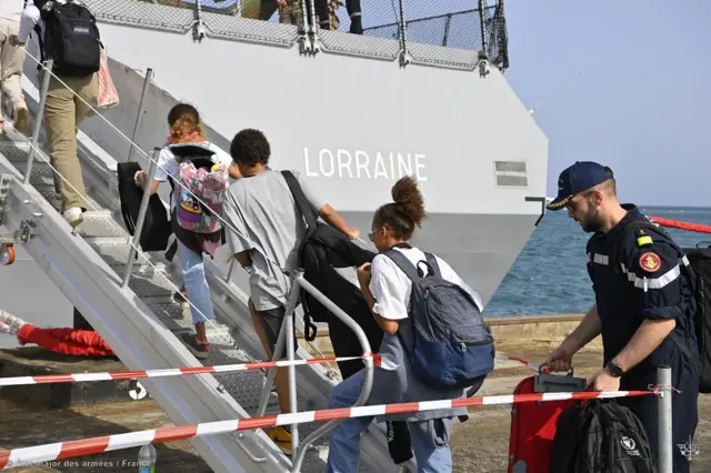 Evacuees board a French naval ship in Port Sudan