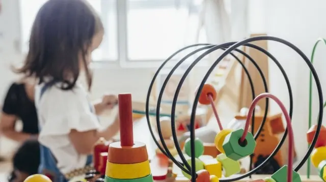 A child plays with wooden toys