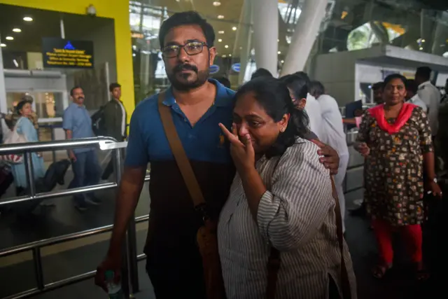 Indian nationals evacuated from Sudan embrace as they arrive in Chennai, India