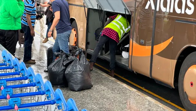 Black bags of possessions being unloaded at Larnaca Airport, Cyprus