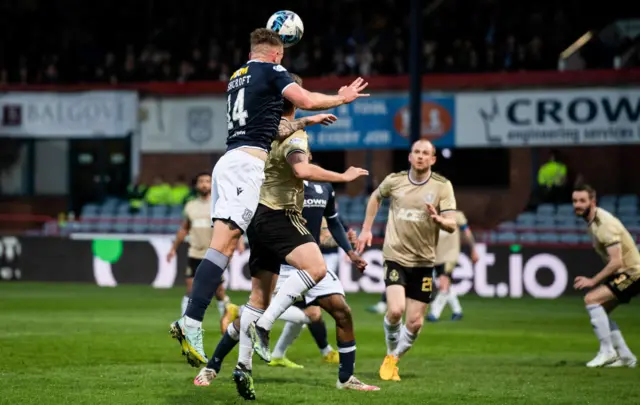 Dundee's Lee Ashcroft heads for goal