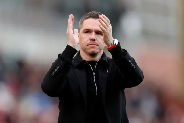 Marc Skinner applauds the travelling Man Utd fans.