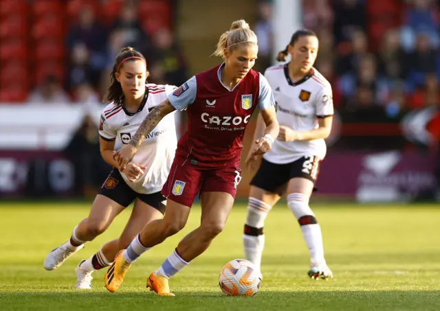 Rachel Daly dribbles through the middle.