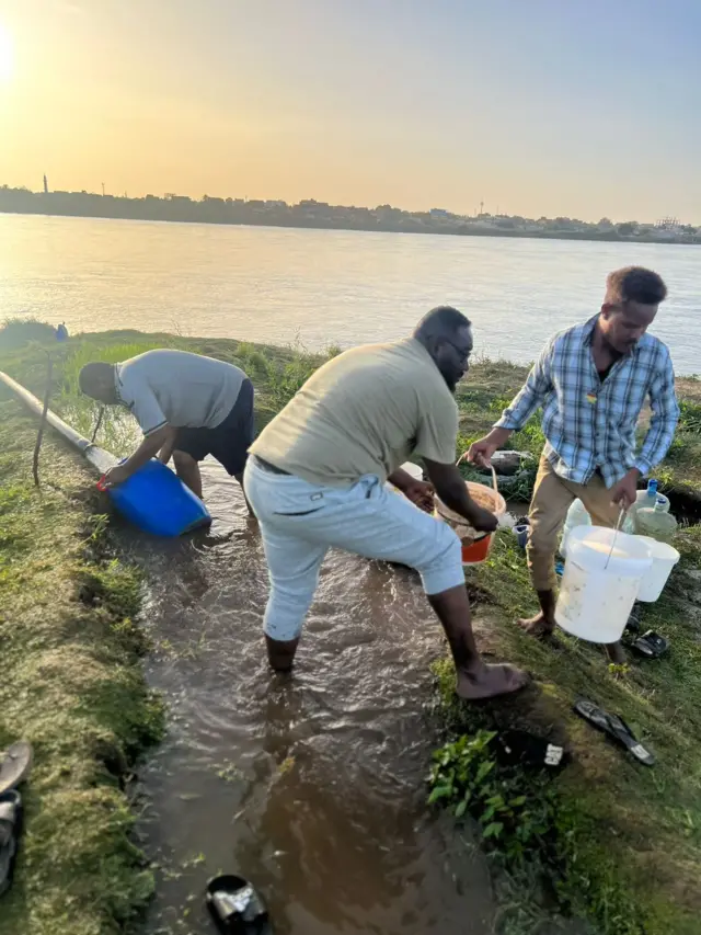 Bashir Hassan and others collect water