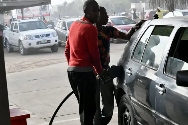 A fuel attendant fills a tank at a fuel station in Kano, northwest Nigeria, on February 8, 2023