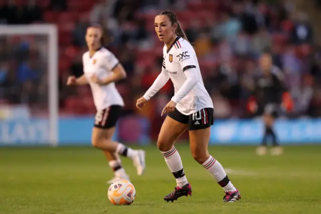 Katie Zelem controls the ball in midfield.