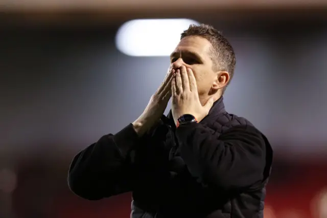 Marc Skinner celebrates with the United fans.