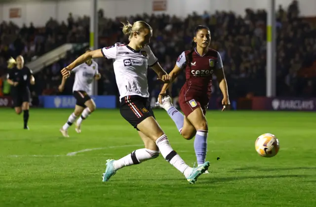 Martha Thomas fires the ball wide.