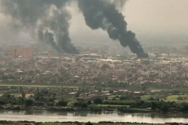 Screengrab showing thick clouds of black smoke over Khartoum