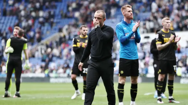 Wigan clap their fans following relegation from the Championship