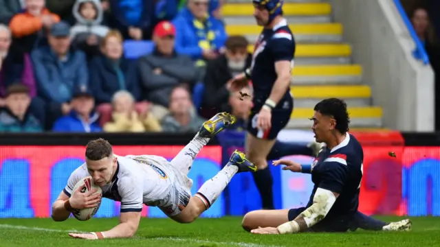 George Williams dives over to score a try for England