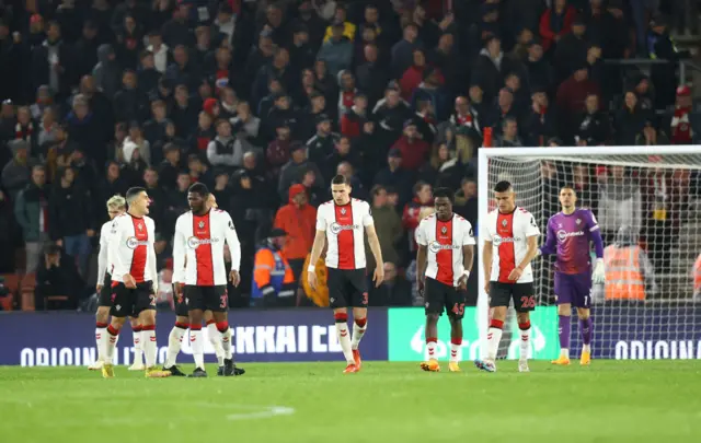 Southampton players trudge back to kick off after conceding.