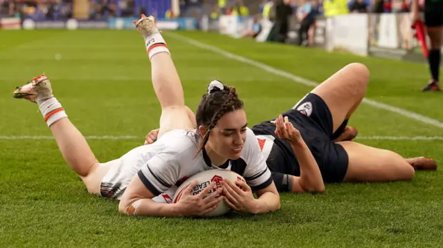 Leah Burke scores her hat-trick try against France