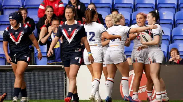 Leah Burke celebrates scoring a try