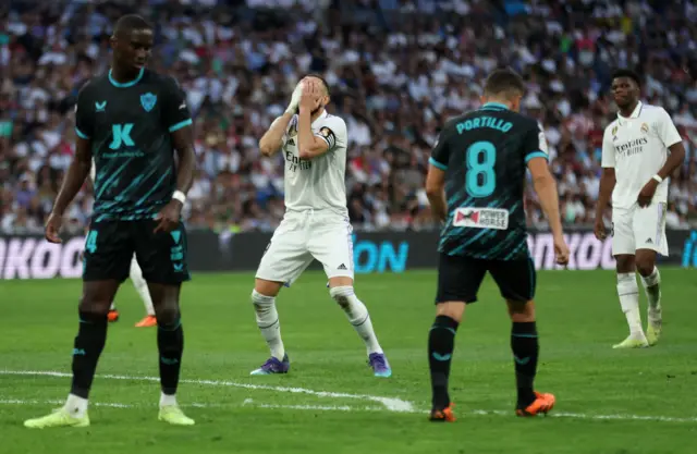 Karim Benzema reacts to his shot hitting the bar.