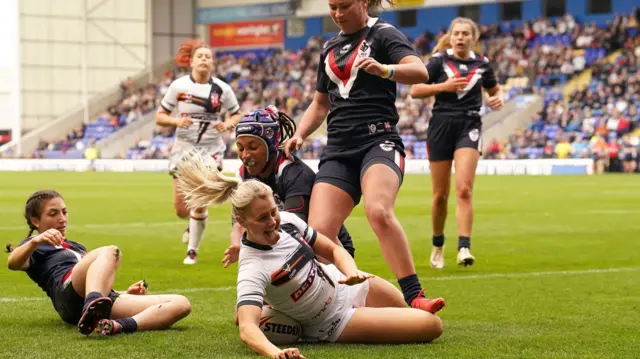 Tara-Jane Stanley grins as she scores England's sixth try