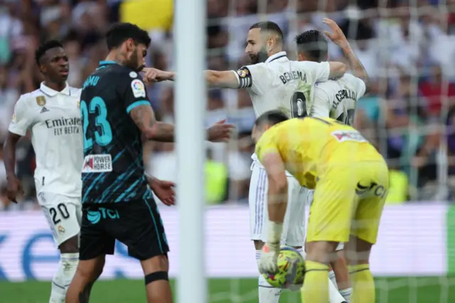 Real Madrid celebrate scoring vs Almeria who slump down desconsolate.