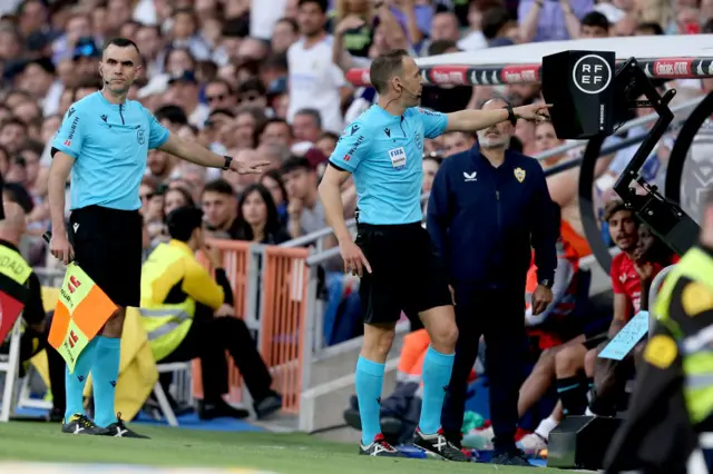 Referee Guillermo Cuadra Fernandez goes to the VAR monitor.