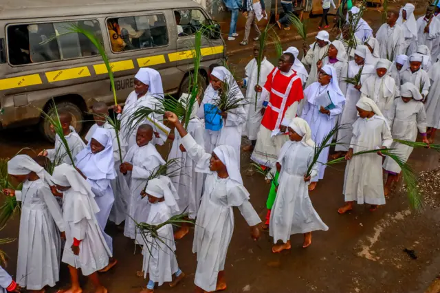 Members of the Legio Maria Church on streets of Kibera celebrating Palm Sunday