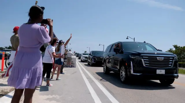 Donald Trump supporters waving at passing car