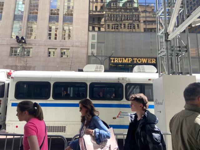 Pedestrians walk in front of Trump Tower